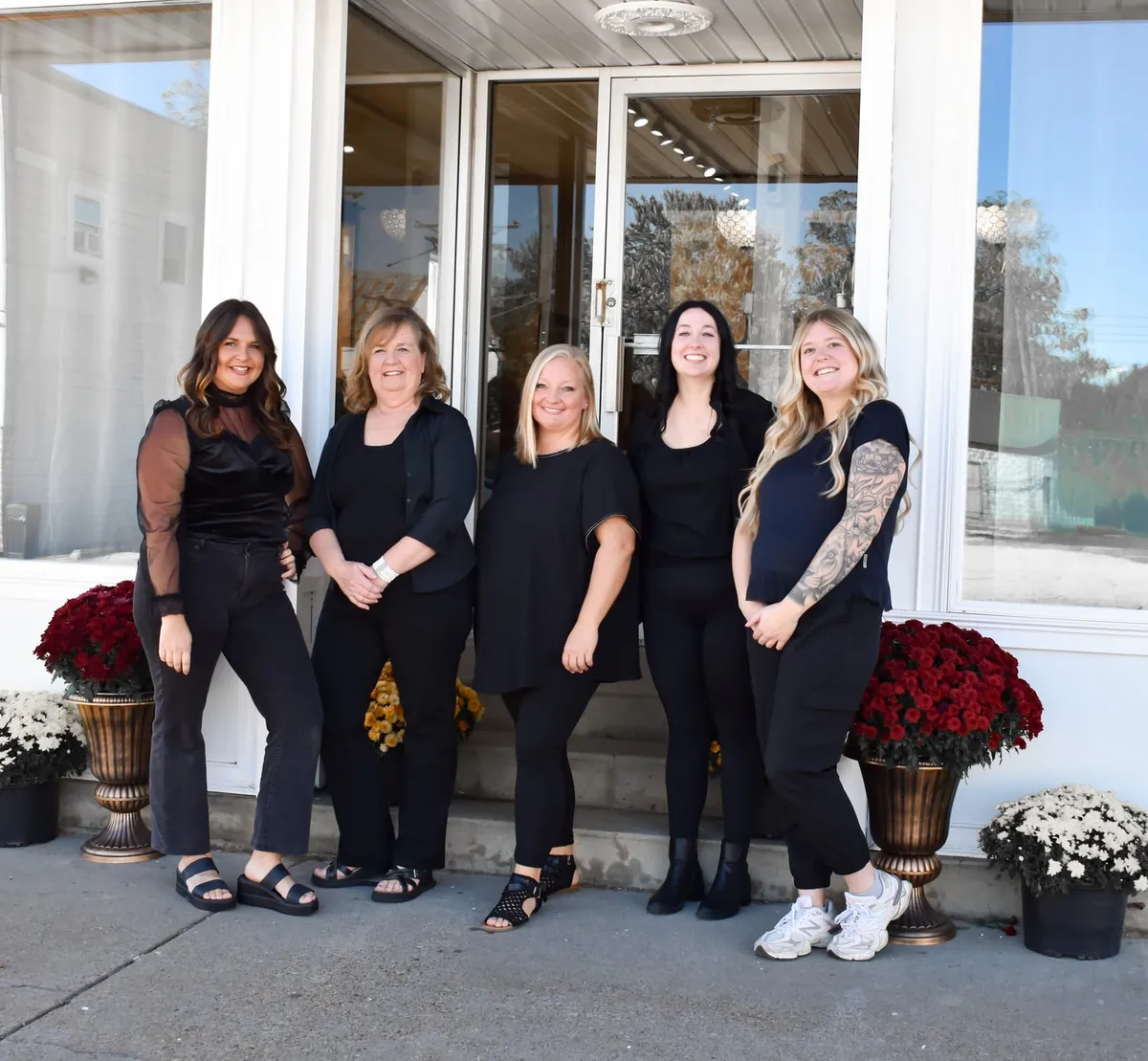 The five Melrose Place Salon providers standing outside the salon entrance.
