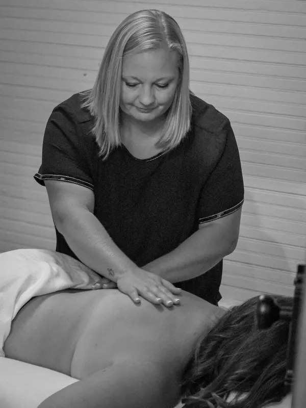 Becca Heidel giving a back massage, black and white
